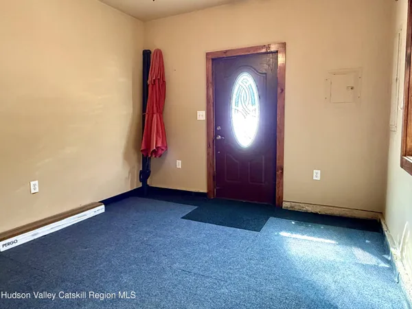 an empty room with windows and closet