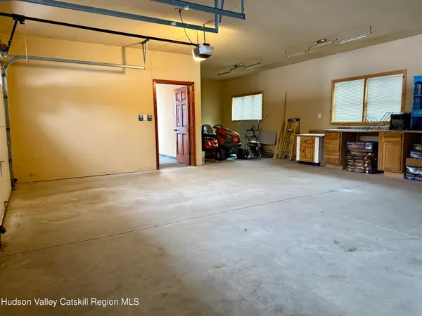 a view of a big room with air conditioner duct and materials on floor