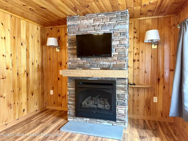 a living room with a fireplace and a flat screen tv
