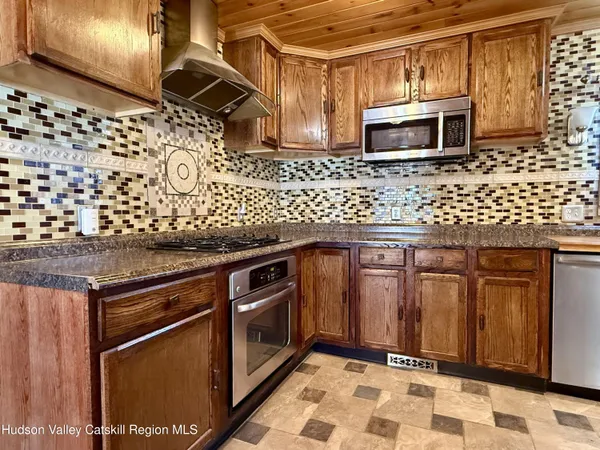 a kitchen with granite countertop wooden cabinets and stainless steel appliances