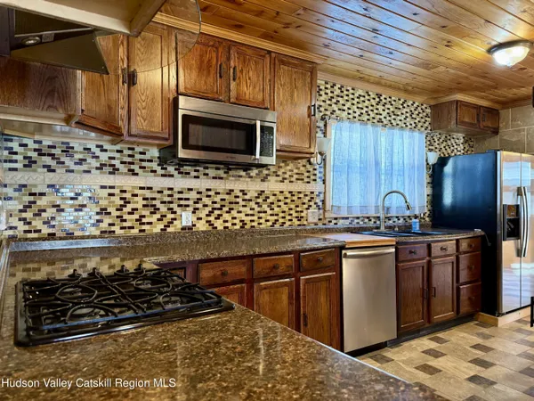 a kitchen with stainless steel appliances a stove a sink and a microwave