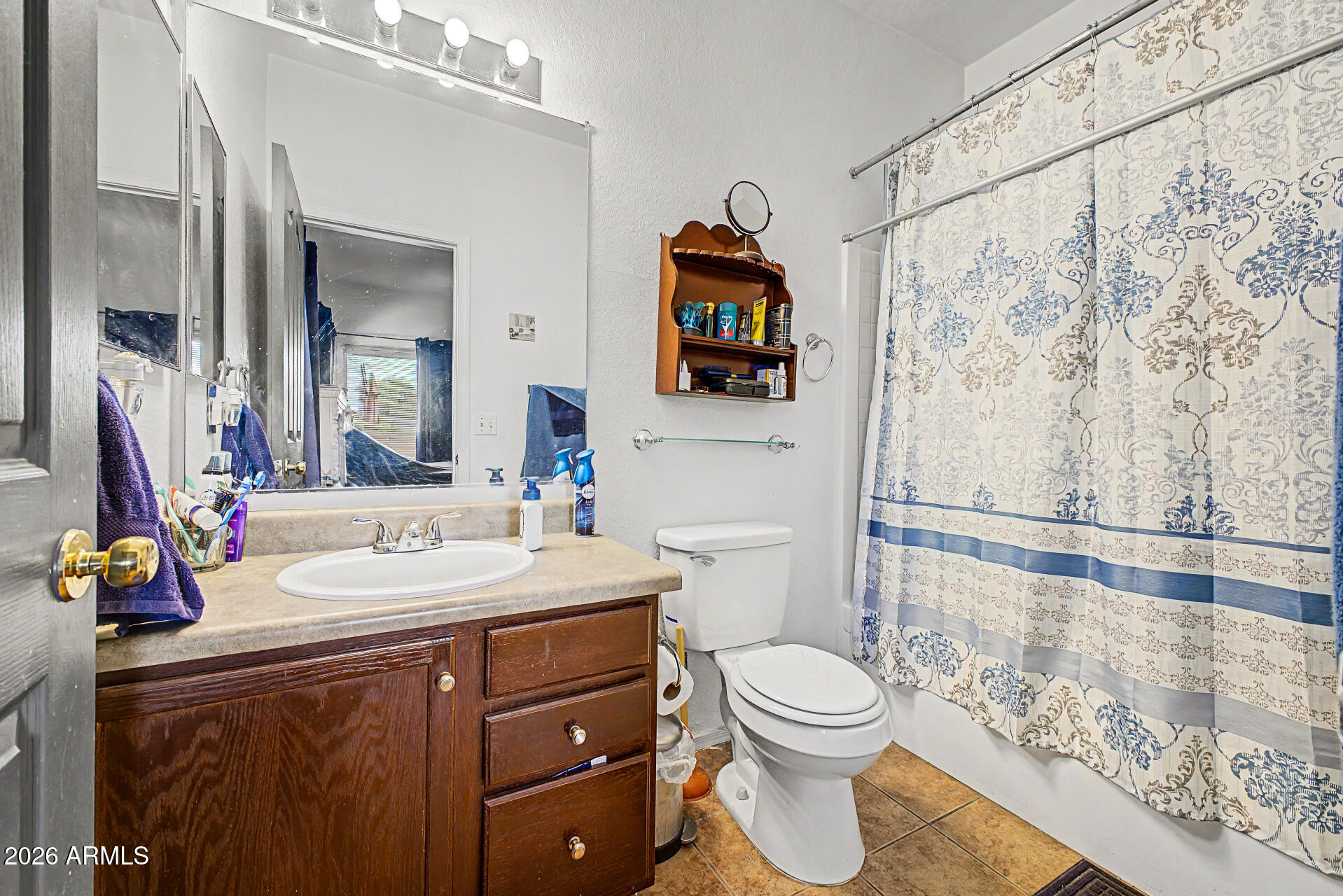 9730 West Payson Road Tolleson, AZ 85353 - Photo 18 of 57 a bathroom with a toilet sink and mirror