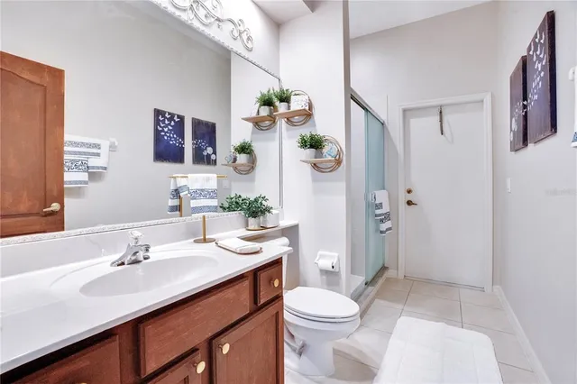 a spacious bathroom with a tub sink and mirror