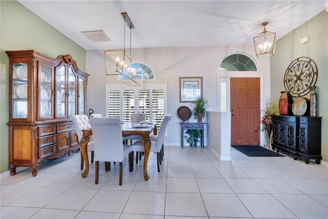 a view of a dining room with furniture and chandelier