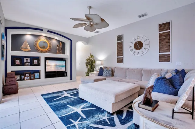 a living room with furniture and painting on the wall