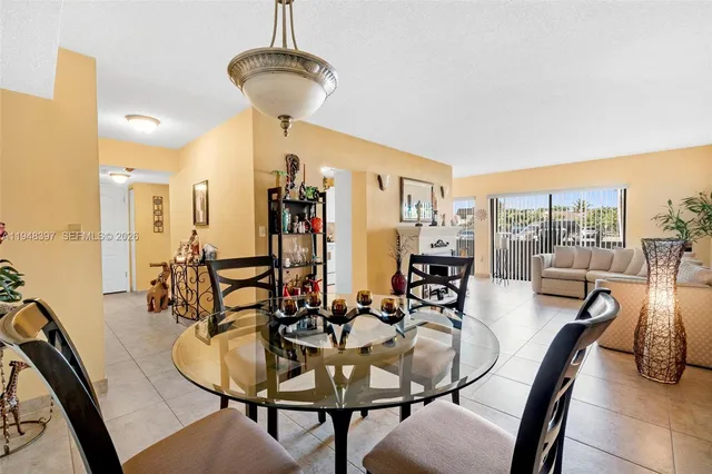 a dining room with furniture and a chandelier