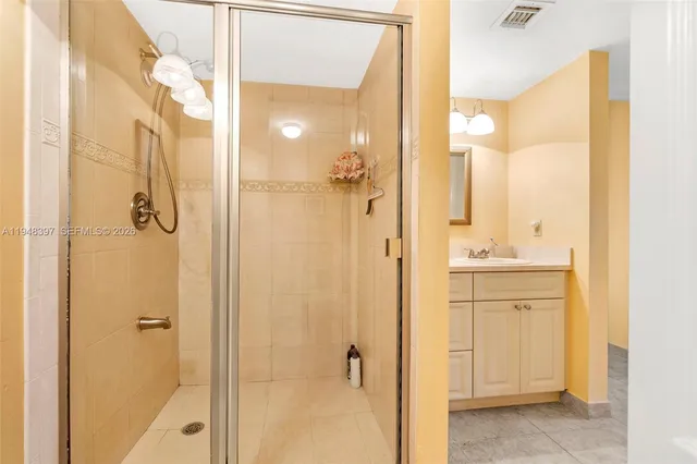 a bathroom with a sink a mirror and a shower