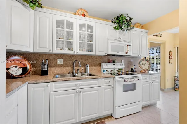 a kitchen with stainless steel appliances white cabinets and a stove