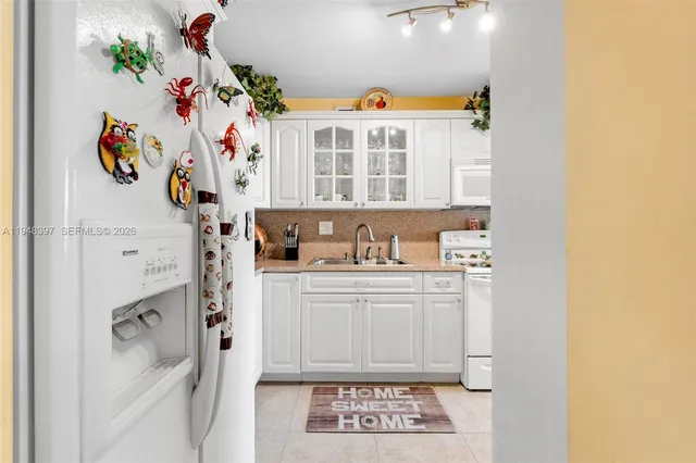 a kitchen with a refrigerator and cabinets