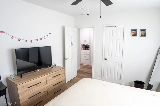 a bedroom with a bed and flat screen tv