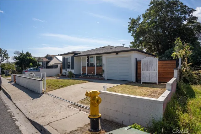 a view of a house with pool and chairs
