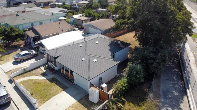 an aerial view of a house with a yard and trees