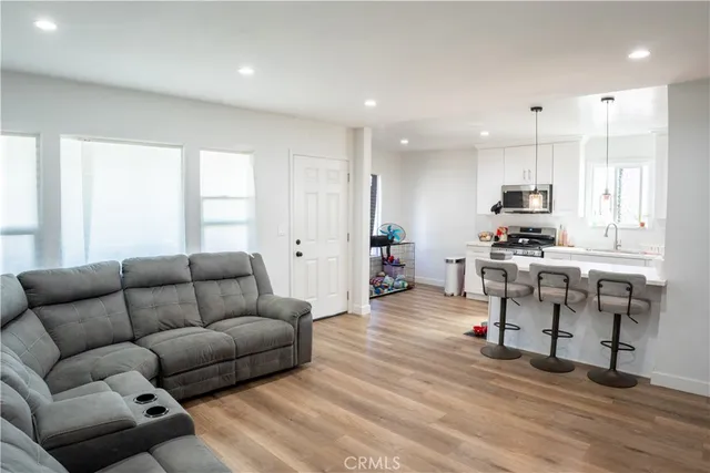 a living room with furniture and kitchen view