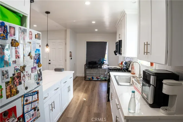 a kitchen with a sink appliances and cabinets