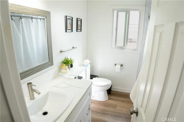 a white toilet sitting next to a bathroom sink