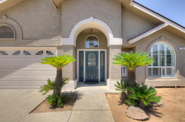 a view of a brick house with potted plants