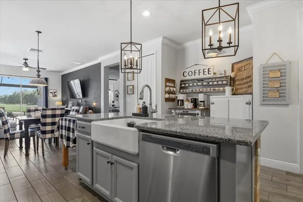 a kitchen with cabinets a sink outdoor seating and view living room