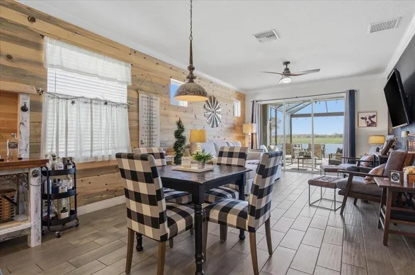 a view of a dining room and livingroom with furniture window and wooden floor