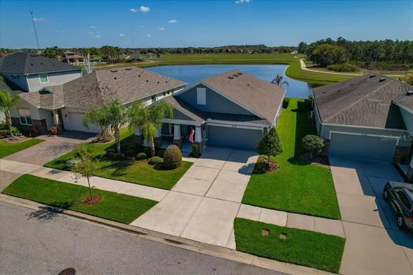 an aerial view of a house with a garden and deck