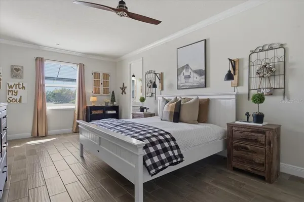 a bedroom with a large bed and a chandelier