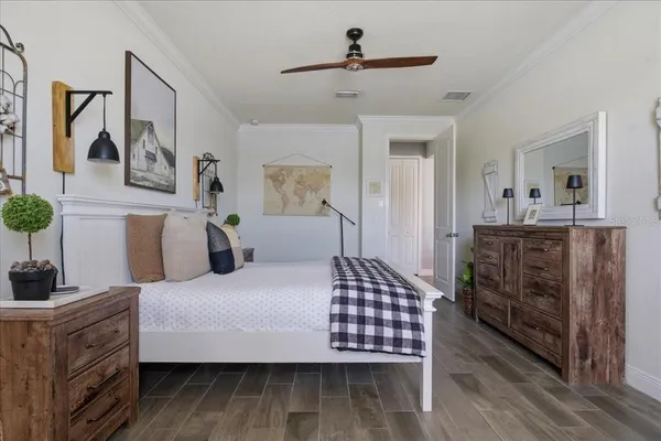 a bedroom with a bed and dresser with mirror