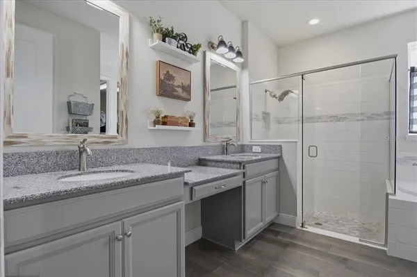 a bathroom with a granite countertop sink mirror and