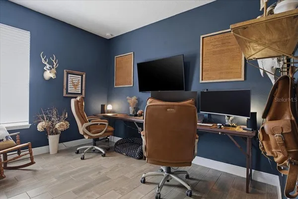 a view of a workspace with furniture and a window