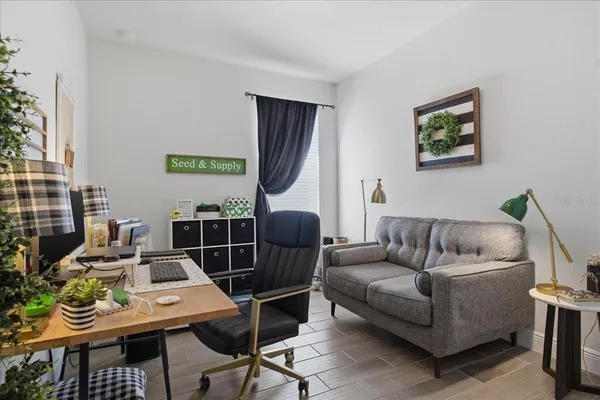 a living room with furniture a rug and a wall painting