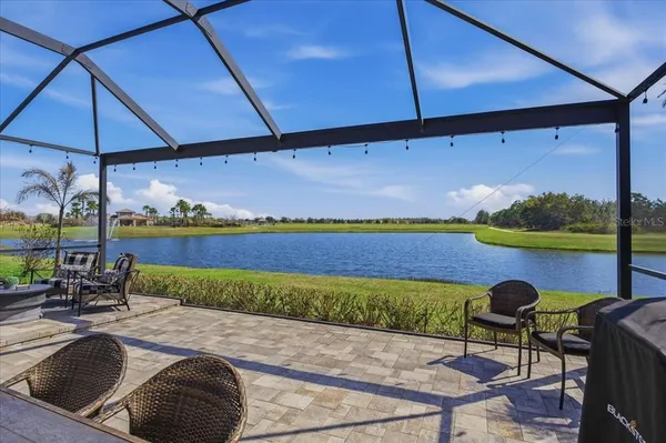 a view of swimming pool with outdoor seating and a umbrella