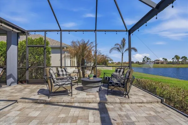 a view of a patio with a table and chairs under an umbrella