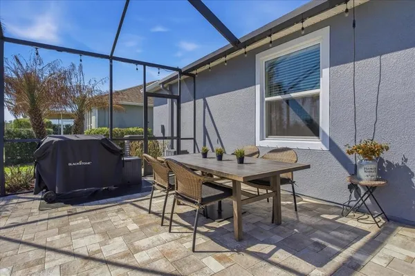 a view of backyard with outdoor seating a patio and plants