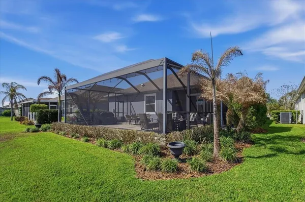 a view of a house with a big yard and potted plants