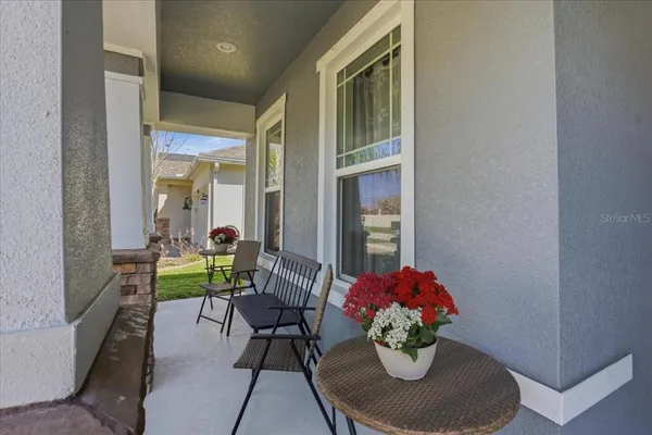 a dining room with furniture and a potted plant