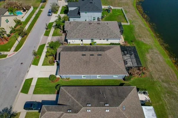 an aerial view of a house with garden space and street view