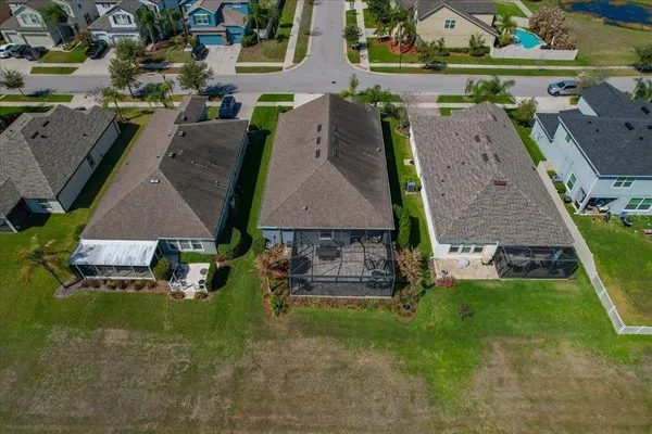 an aerial view of multiple houses with a yard