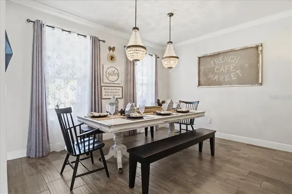 a view of a dining room with furniture window and wooden floor