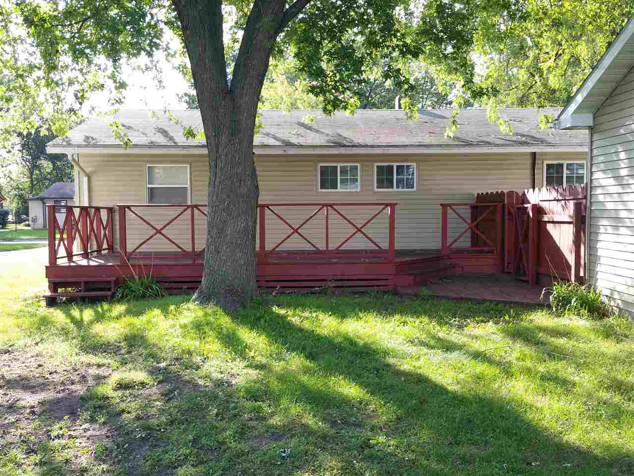 7809 Randy Road Machesney Park, IL 61115 - Photo 14 of 20 a view of a yard in front of a house with plants and a large tree