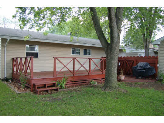 7809 Randy Road Machesney Park, IL 61115 - Photo 15 of 20 a backyard of a house with barbeque oven and large trees