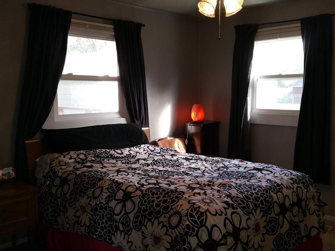 7809 Randy Road Machesney Park, IL 61115 - Photo 10 of 20 a bedroom with a bed next to a window and a lamp