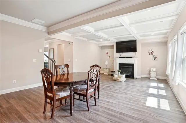 a dining room with furniture a fireplace and wooden floor