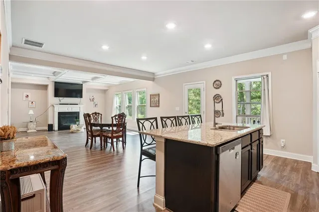 a living room with furniture a dining table and a wooden floor