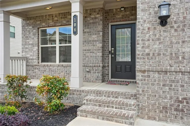 a front view of a brick house with a window and a window