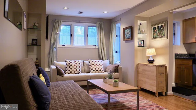 a living room with furniture and wooden floor