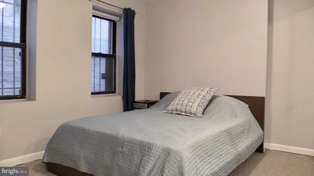 a bedroom with a bed and mirror