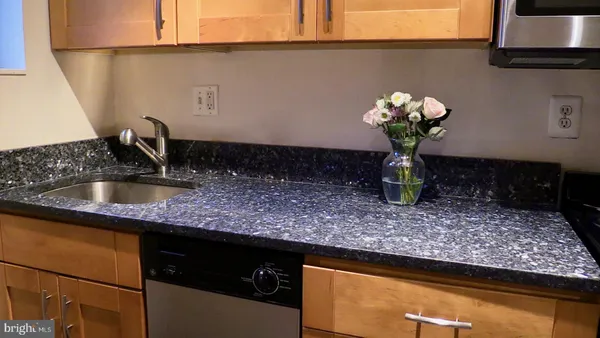 a kitchen with a sink a counter space and cabinets