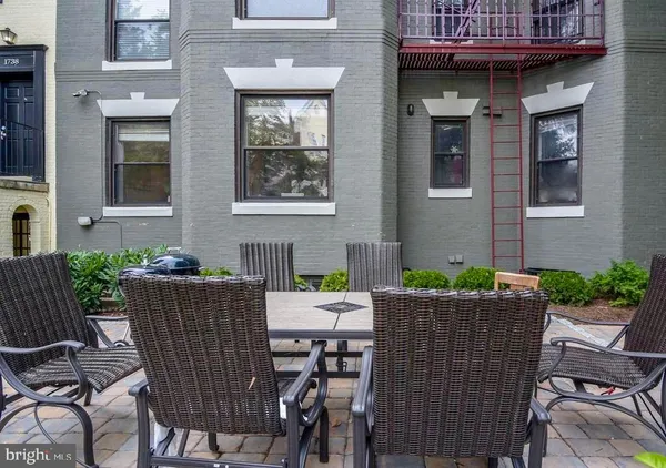 a view of a patio with table and chairs