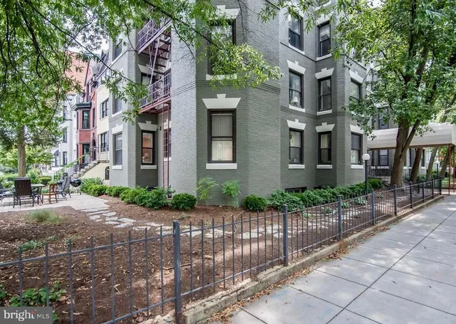 a view of a brick building next to a road