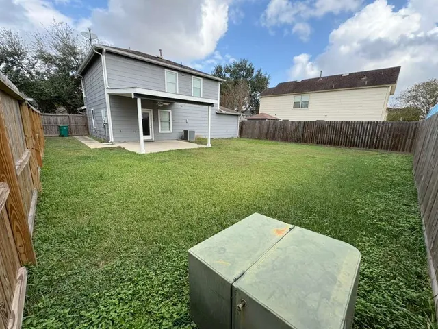 a backyard of a house with a garden and plants