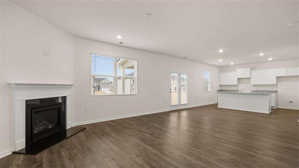 97 Defilippe Drive Statham, GA 30666 - Photo 23 of 58 a view of an empty room with wooden floor and a fireplace