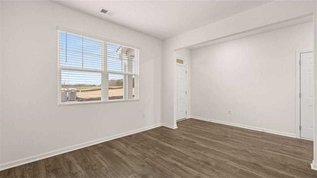 97 Defilippe Drive Statham, GA 30666 - Photo 28 of 58 an empty room with wooden floor and windows